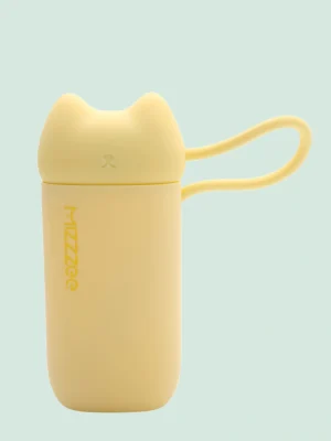 Handheld pink sonic suction massager resting on a luxury silk background
